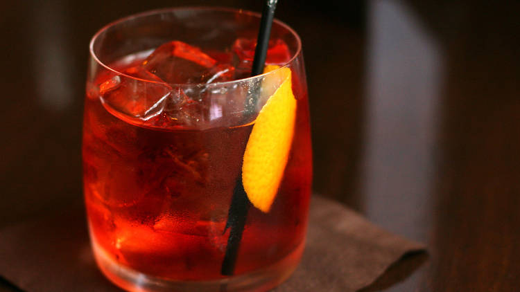 A close up shot of a negroni cocktail