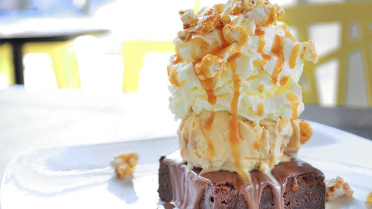 ice cream and popcorn on top of a brownie