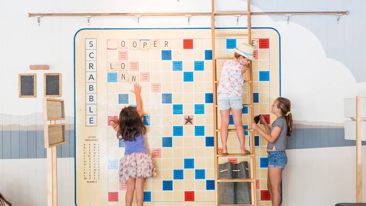 Kids playing on a huge Scrabble board