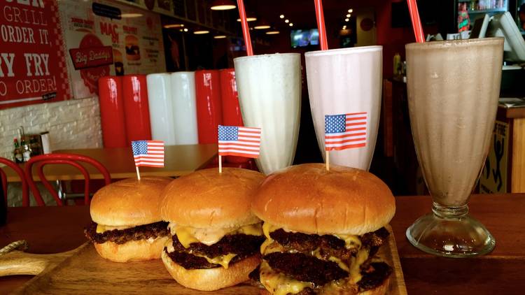 burgers with flags in front of shakes