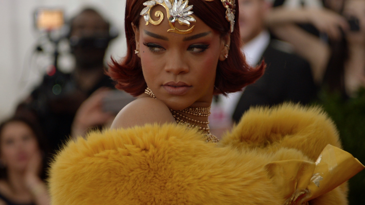 Rihanna wears a fluffy yellow robe at the Met Gala in 2015