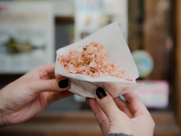 Top rice balls with bonito flakes...