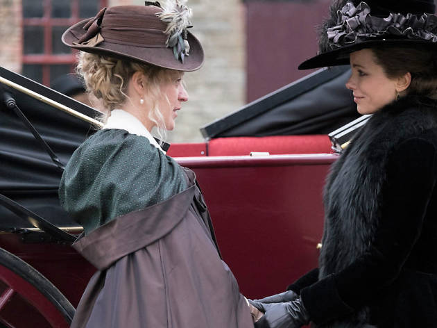 Love and Friendship film still, two ladies holding hands in front of car