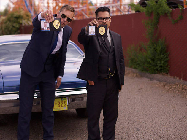 War On Everyone two policemen in front of vehicle with badges out