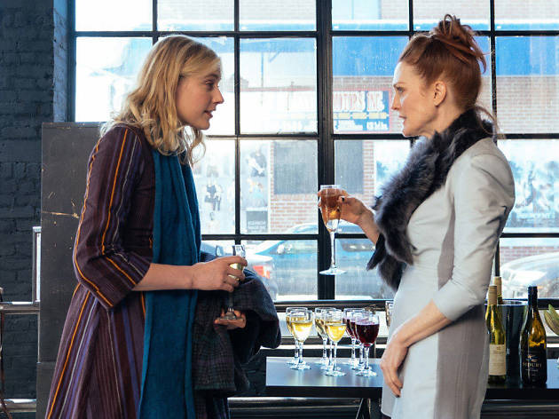 Maggie's Plan Two women stand talking with wine