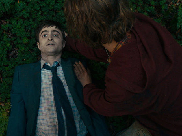 Swiss Army Man Daniel Radcliffe lies down on mossy ground in Swiss Army Man