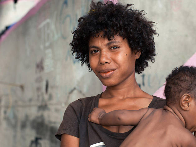 the Opposition Papua New Guinean woman holds a child to her chest