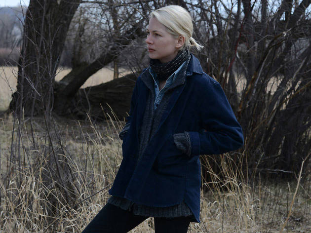 Certain Women Michelle Williams in an open field at dusk