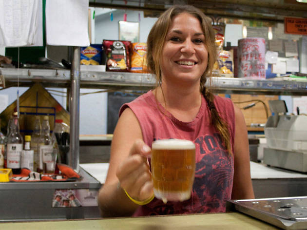 Hotel Coolgardie Woman working behind a bar holding a beer