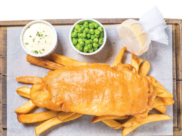 Fish and Chips a plate of fish and chips with lemon, tartare sauce and peas