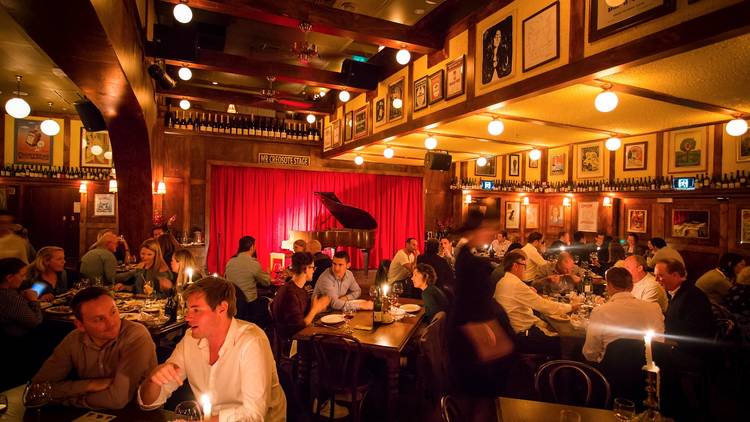 Interior with stage and piano at Hubert