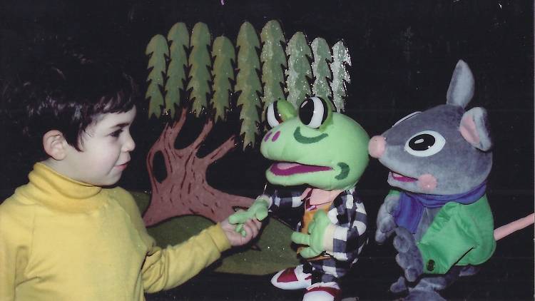 Kid participating in a puppet show