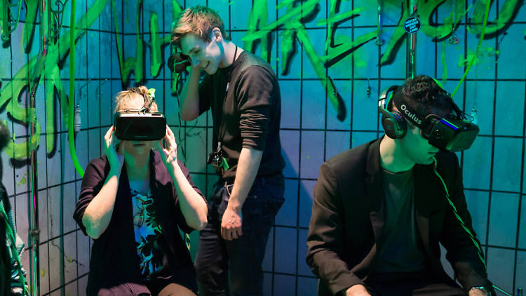 Three people wearing virtual reality headsets