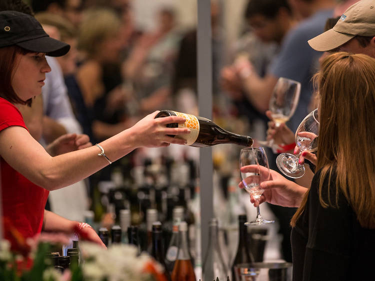 A woman pours wine for guests at last year's festival