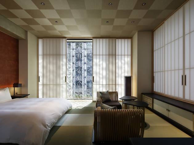 Sliding washi screens and tatami mats with soft futon beds make up the standard room at the Hoshinoya Hotel.