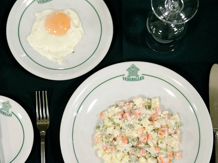 Eat a croquette with a fork and knife at Pastelaria Versailles