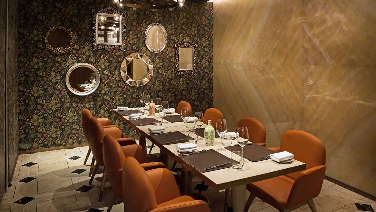 Private dining room with mirrors and orange seats