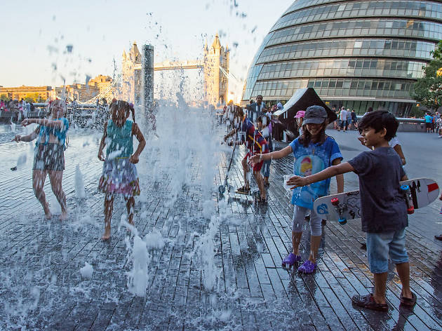 Children play in fountains by City Hall, London Children play in fountains by City Hall, London
