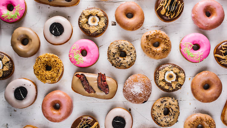 A variety of donuts laid out over a table