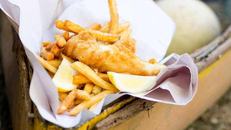 A stock photo of fried fish and chips in paper