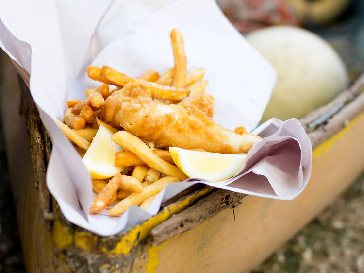 A stock photo of fried fish and chips in paper