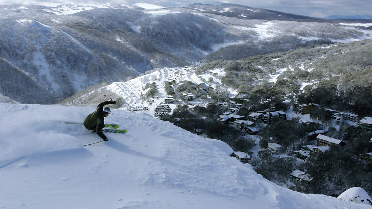 Skiier carves up the snow overlooking Falls Creek ski resort