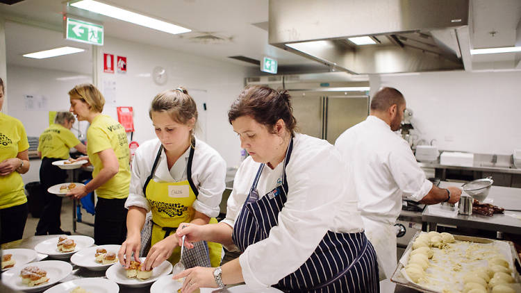 Two chefs preparing meals