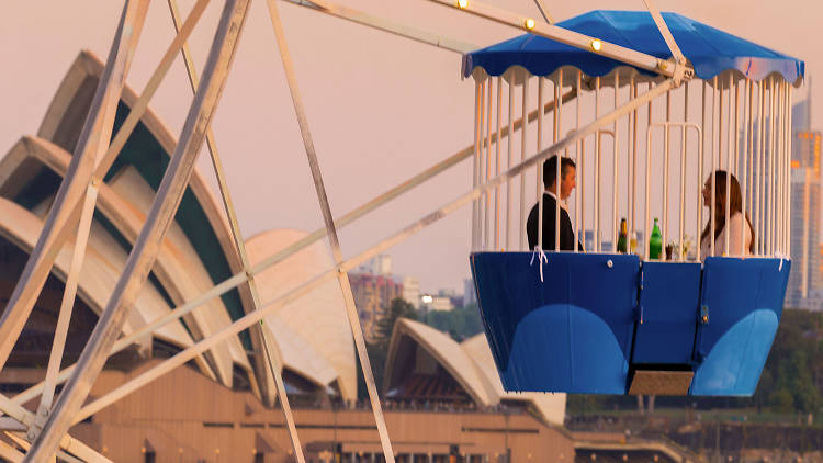 A couple on the ferris wheel with the Opera House in the background