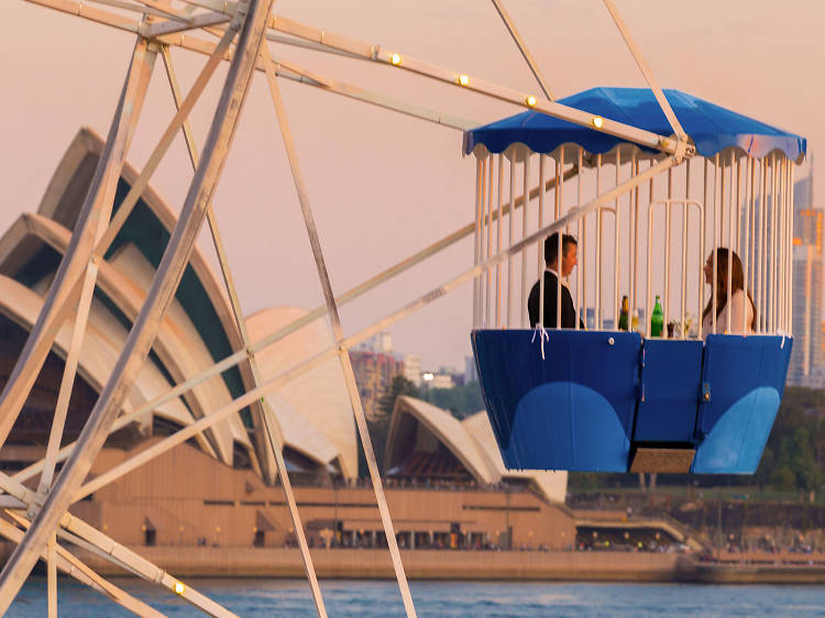  A couple on the ferris wheel with the Opera House in the background