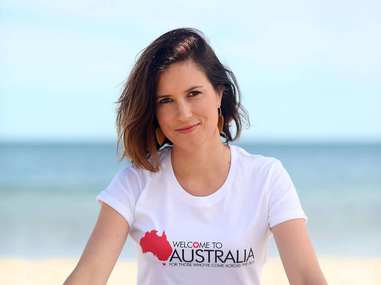 Missy Higgins sitting on a beach