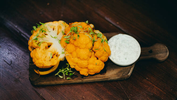 Roasted tandoori cauliflower with mint cucumber dip at 1886 Bar