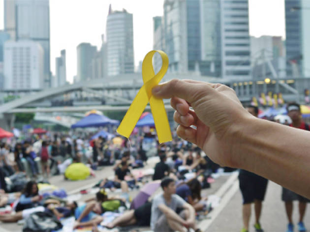 A protestor holds up a yellow ribbon at Occupy Central 2014 A protestor holds up a yellow ribbon at Occupy Central 2014