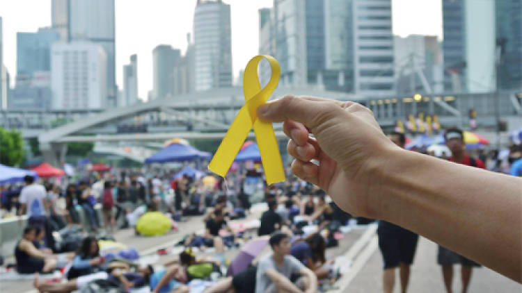 A protestor holds up a yellow ribbon at Occupy Central 2014