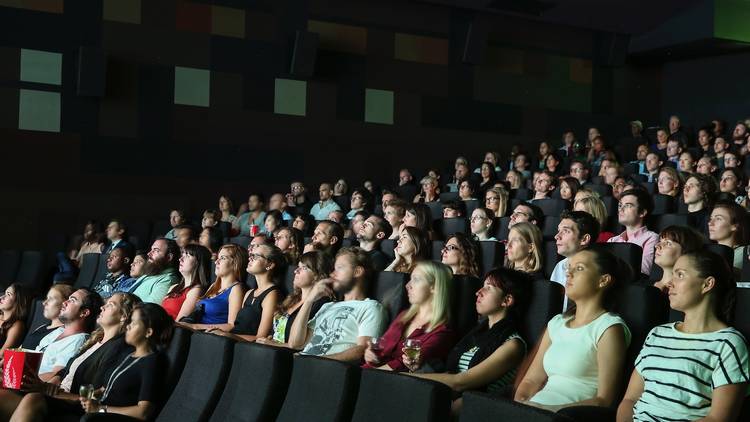 Movie goers in a cinema watching a movie