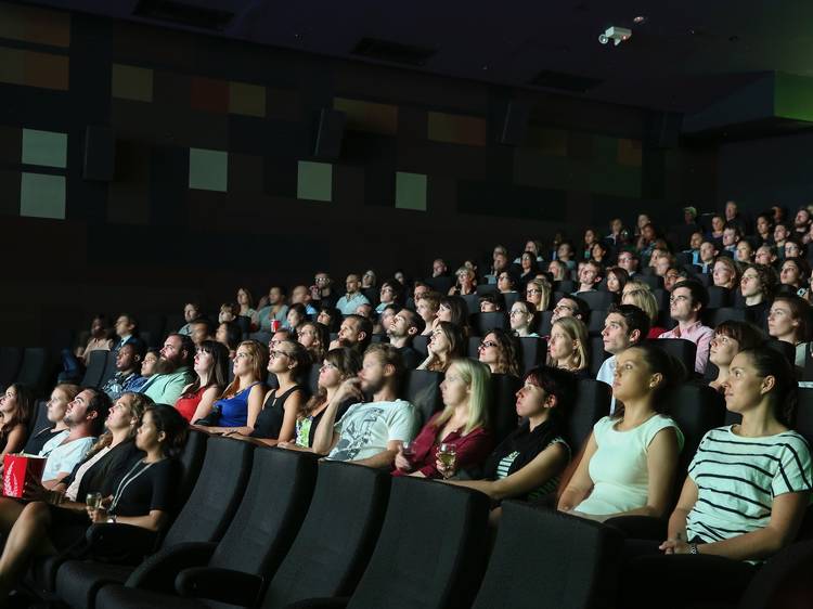 Movie goers in a cinema watching a movie