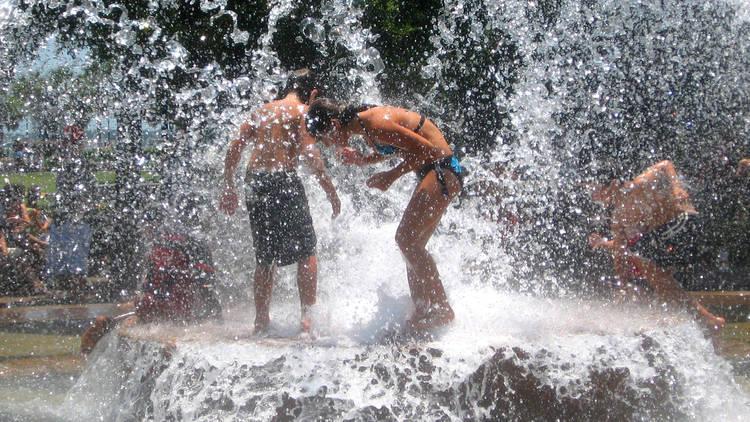 People playing in the water fountain at a a water park