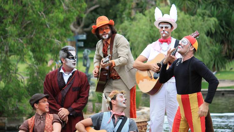 Wind in the Willows performers pose in a garden.