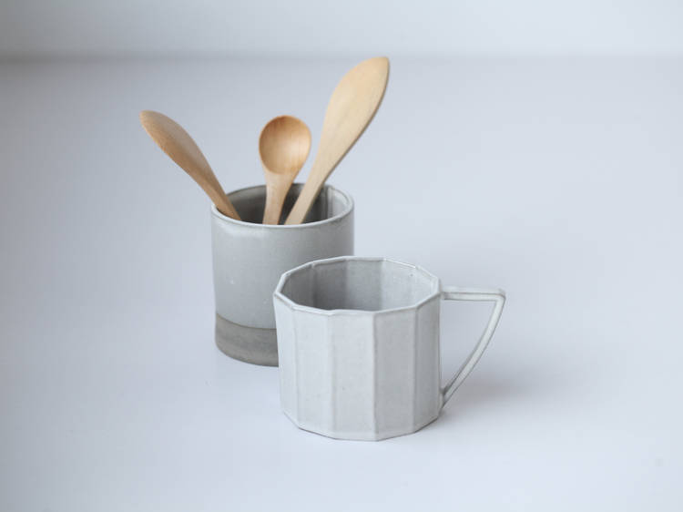 Ceramic cup, wooden spoon and wooden butter spreader