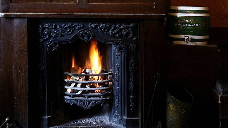 Grab a seat by the fire at The Holly Bush