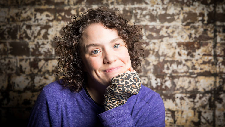 Jess Thom looking to camera with leopard print glove