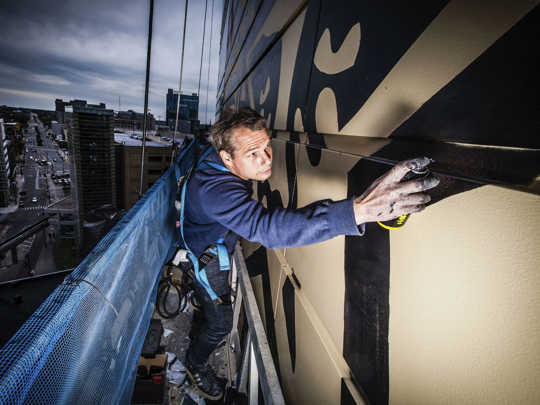 Shepard Fairley painting a mural