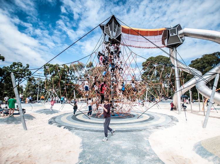 A playground with a sandy ground.