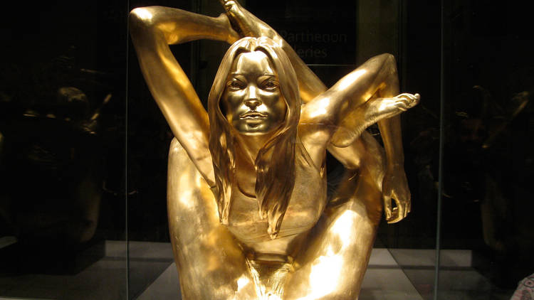 Kate Moss made of pure gold doing a painful-looking yoga pose