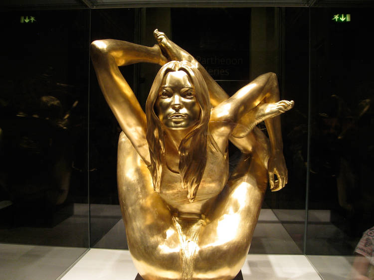 Kate Moss made of pure gold doing a painful-looking yoga pose