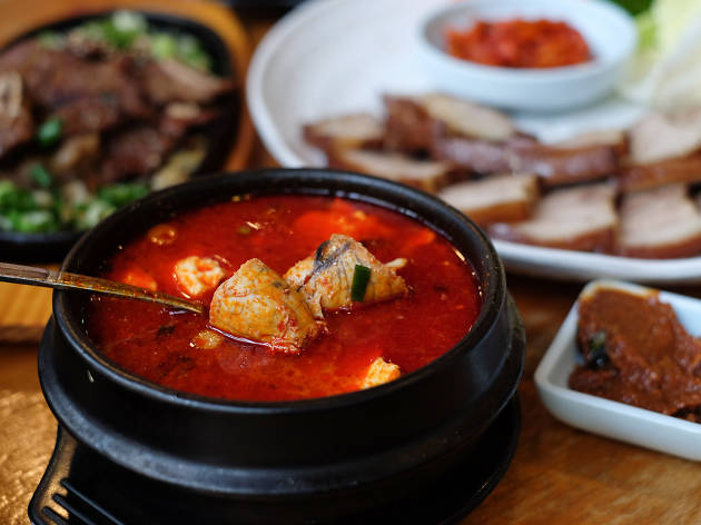 BCD Tofu House A bowl of red soup with tofu