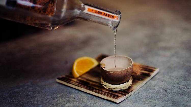 Mezcal pours at Guelaguetza