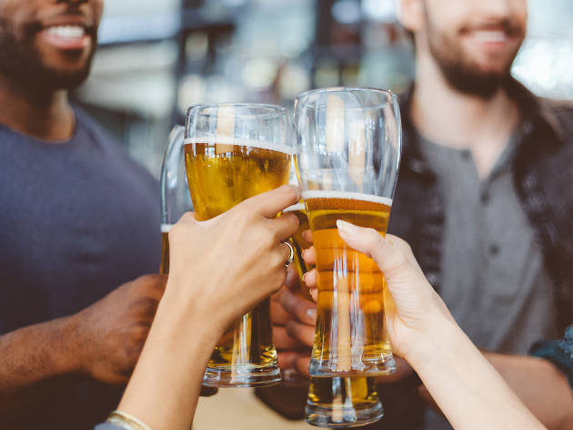 Friends toasting with beer in a pub 491872506