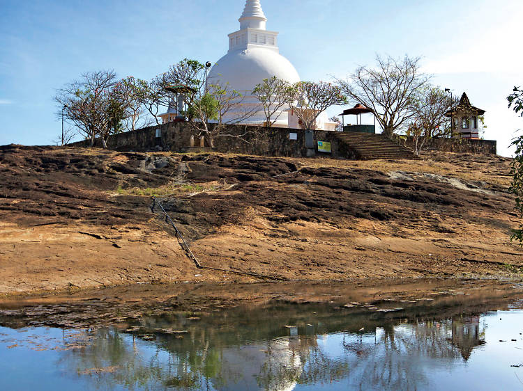 Visit Thanthrimale where the stupa is lit up for Poya