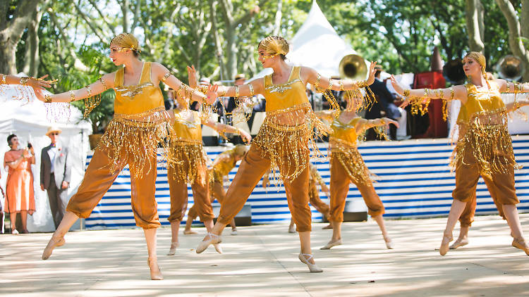 Dancers in 1920s-style gold outfits.