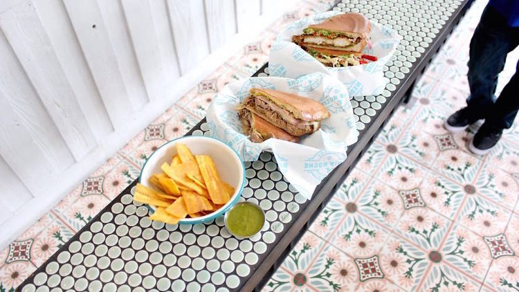 Three plates of Cuban food on a table